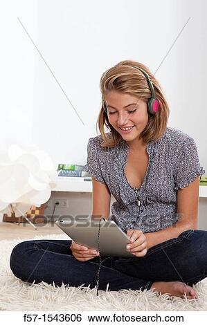 Stock Photograph - Teenager communicating with a digital tablet. Fotosearch