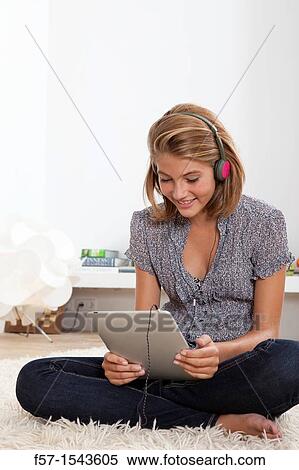 Stock Photography - Teenager communicating with a digital tablet. Fotosearch