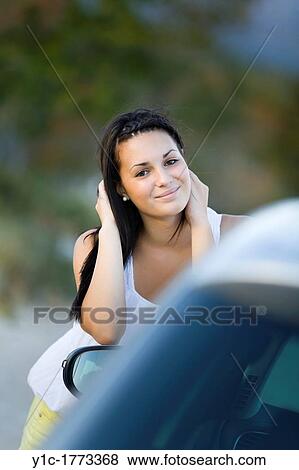 Stock Photo - Teenager girl next to a car. Fotosearch
