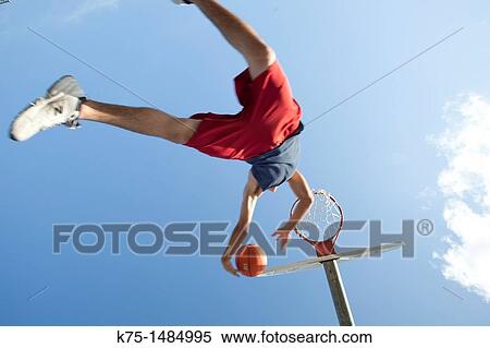 Teenager jumping with basketball View Large Photo Image Stock Photography - Teenager jumping with basketball. Fotosearch