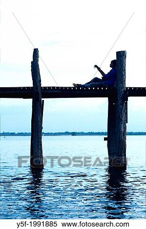 Teenager playing guitar at U Bein bridge. View Large Photo Image Stock Photography - Teenager playing guitar at U Bein bridge.. Fotosearch