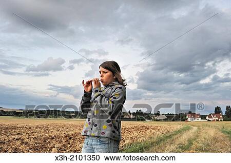 teenager playing whistle with a straw in a field, France, Europe. View Large Photo Image Stock Image - teenager playing whistle with a straw in a field, France, Europe.. Fotosearch