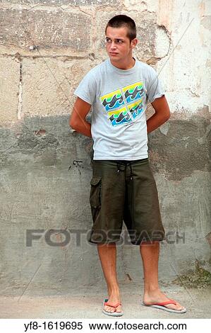 Teenager standing in a street View Large Photo Image Stock Photography - Teenager standing in a street. Fotosearch