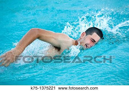 Stock Image - teenager swimming in pool. Fotosearch