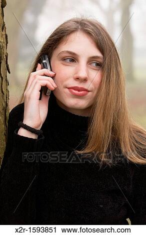 Teenager using her mobile phone View Large Photo Image Stock Image - Teenager using her mobile phone. Fotosearch