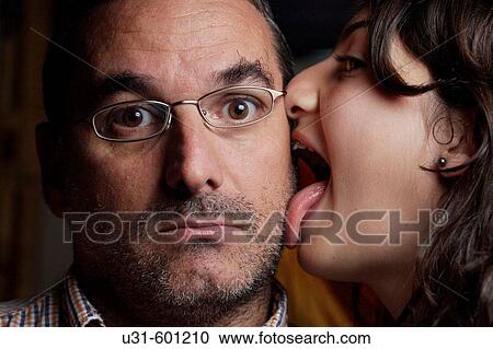 Teenager with brackets licks his dad's cheek View Large Photo Image Stock Image - Teenager with brackets licks his dad's cheek. Fotosearch