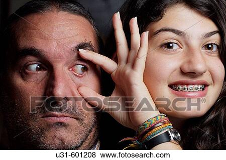 Teenager with brackets opens his dad's eye View Large Photo Image Stock Photo - Teenager with brackets opens his dad's eye. Fotosearch
