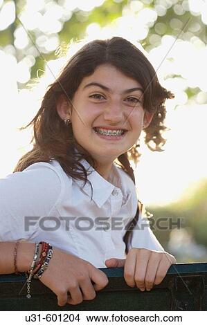 Picture - Teenager with brackets smiles at the camera. Fotosearch