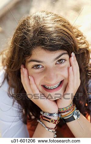 Stock Photograph - Teenager with brackets smiles at the camera. Fotosearch