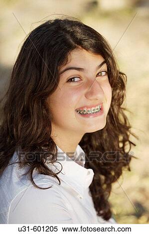 Teenager with brackets smiles at the camera View Large Photo Image Stock Photography - Teenager with brackets smiles at the camera. Fotosearch
