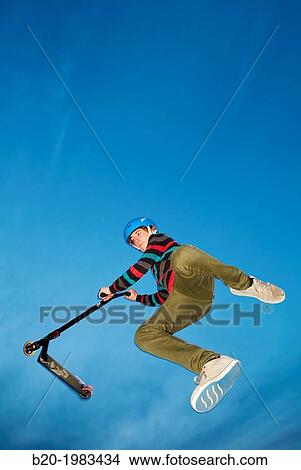 Picture - Teenager with city scooter in Skate park, Irun, Gipuzkoa, Basque country, Spain.. Fotosearch