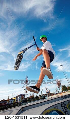 Teenager with city scooter in Skate park, Irun, Gipuzkoa, Euskadi, Spain View Large Photo Image Stock Image - Teenager with city scooter in Skate park, Irun, Gipuzkoa, Euskadi, Spain. Fotosearch