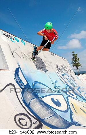 Teenager with city scooter in Skate park, Irun, Gipuzkoa, Euskadi, Spain View Large Photo Image Stock Image - Teenager with city scooter in Skate park, Irun, Gipuzkoa, Euskadi, Spain. Fotosearch