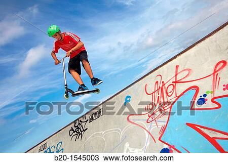 Teenager with city scooter in Skate park, Irun, Gipuzkoa, Euskadi, Spain View Large Photo Image Stock Image - Teenager with city scooter in Skate park, Irun, Gipuzkoa, Euskadi, Spain. Fotosearch