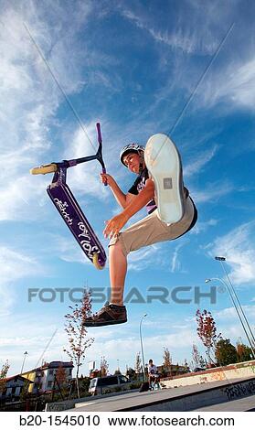 Teenager with city scooter in Skate park, Irun, Gipuzkoa, Euskadi, Spain View Large Photo Image Stock Image - Teenager with city scooter in Skate park, Irun, Gipuzkoa, Euskadi, Spain. Fotosearch