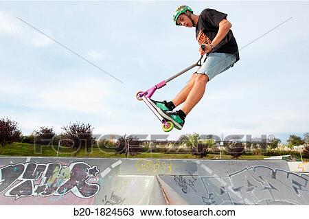 Stock Image - Teenager with city scooter in Skate park, Leioa, Bizkaia, Basque Country, Spain. Fotosearch