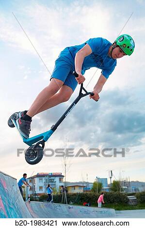 Teenager with city scooter in Skate park, Irun, Gipuzkoa, Basque country, Spain. View Large Photo Image Stock Image - Teenager with city scooter in Skate park, Irun, Gipuzkoa, Basque country, Spain.. Fotosearch