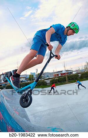 Teenager with city scooter in Skate park, Irun, Gipuzkoa, Basque country, Spain. View Large Photo Image Stock Image - Teenager with city scooter in Skate park, Irun, Gipuzkoa, Basque country, Spain.. Fotosearch