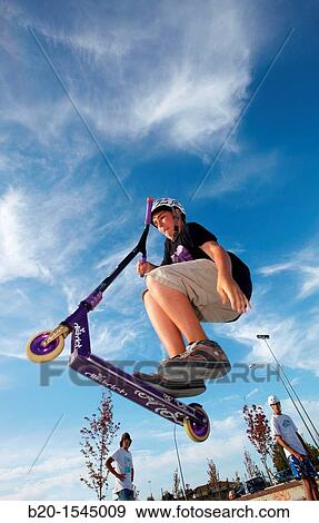Teenager with city scooter in Skate park, Irun, Gipuzkoa, Euskadi, Spain View Large Photo Image Stock Photo - Teenager with city scooter in Skate park, Irun, Gipuzkoa, Euskadi, Spain. Fotosearch