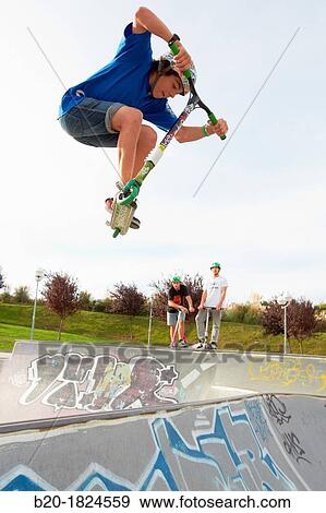 Stock Photo - Teenager with city scooter in Skate park, Leioa, Bizkaia, Basque Country, Spain. Fotosearch