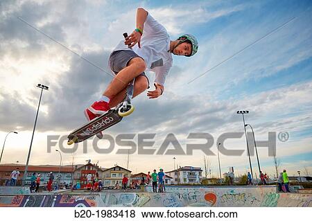 Teenager with city scooter in Skate park, Irun, Gipuzkoa, Basque country, Spain. View Large Photo Image Stock Photo - Teenager with city scooter in Skate park, Irun, Gipuzkoa, Basque country, Spain.. Fotosearch