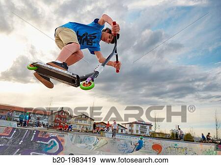 Teenager with city scooter in Skate park, Irun, Gipuzkoa, Basque country, Spain. View Large Photo Image Stock Photo - Teenager with city scooter in Skate park, Irun, Gipuzkoa, Basque country, Spain.. Fotosearch