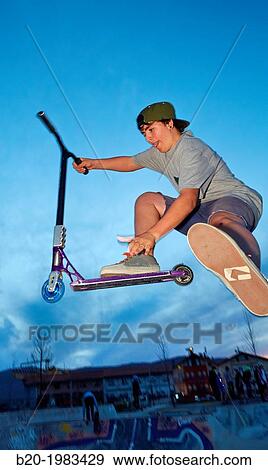 Teenager with city scooter in Skate park, Irun, Gipuzkoa, Basque country, Spain. View Large Photo Image Stock Photo - Teenager with city scooter in Skate park, Irun, Gipuzkoa, Basque country, Spain.. Fotosearch