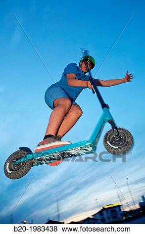 Teenager with city scooter in Skate park, Irun, Gipuzkoa, Basque country, Spain. View Large Photo Image Stock Photo - Teenager with city scooter in Skate park, Irun, Gipuzkoa, Basque country, Spain.. Fotosearch