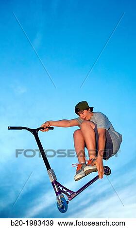 Stock Photo - Teenager with city scooter in Skate park, Irun, Gipuzkoa, Basque country, Spain.. Fotosearch
