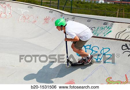 Teenager with city scooter in Skate park, Irun, Gipuzkoa, Euskadi, Spain View Large Photo Image Stock Photograph - Teenager with city scooter in Skate park, Irun, Gipuzkoa, Euskadi, Spain. Fotosearch