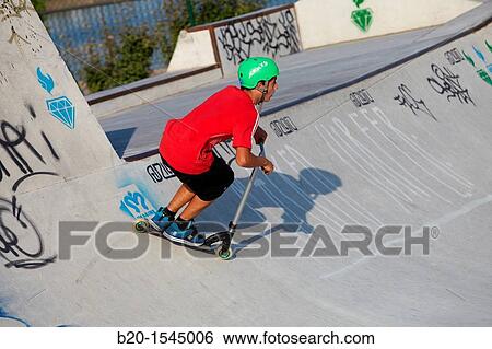 Stock Photograph - Teenager with city scooter in Skate park, Irun, Gipuzkoa, Euskadi, Spain. Fotosearch