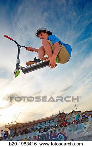 Stock Photograph - Teenager with city scooter in Skate park, Irun, Gipuzkoa, Basque country, Spain.. Fotosearch
