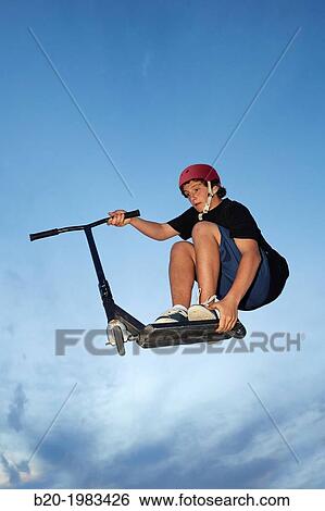 Teenager with city scooter in Skate park, Irun, Gipuzkoa, Basque country, Spain. View Large Photo Image Stock Photograph - Teenager with city scooter in Skate park, Irun, Gipuzkoa, Basque country, Spain.. Fotosearch