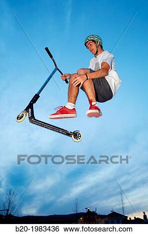 Teenager with city scooter in Skate park, Irun, Gipuzkoa, Basque country, Spain. View Large Photo Image Stock Photograph - Teenager with city scooter in Skate park, Irun, Gipuzkoa, Basque country, Spain.. Fotosearch