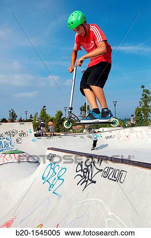 Teenager with city scooter in Skate park, Irun, Gipuzkoa, Euskadi, Spain View Large Photo Image Stock Photography - Teenager with city scooter in Skate park, Irun, Gipuzkoa, Euskadi, Spain. Fotosearch