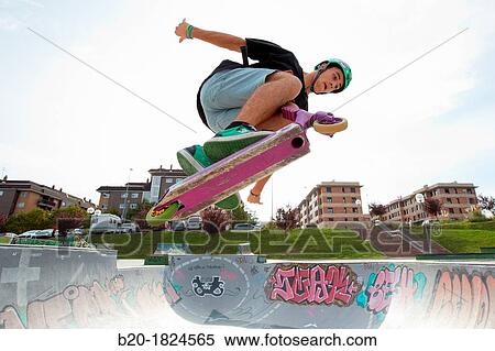 Stock Photography - Teenager with city scooter in Skate park, Leioa, Bizkaia, Basque Country, Spain. Fotosearch