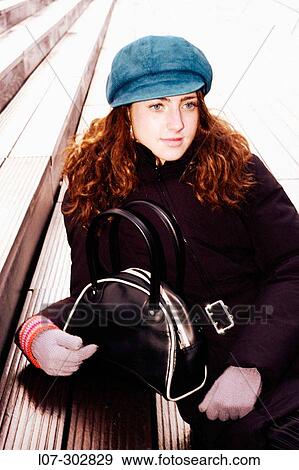 Teenager with trendy cap and bag on steps View Large Photo Image Stock Photo - Teenager with trendy cap and bag on steps. Fotosearch