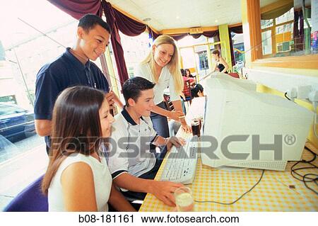 Teenagers at internet cafe View Large Photo Image Stock Image - Teenagers at internet cafe. Fotosearch