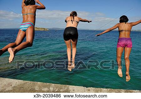 teenagers diving from the top of a sea wall at Treboul, Douarnenez, Finistere department, Brittany region, west of France, western Europe. View Large Photo Image Stock Photograph - teenagers diving from the top of a sea wall at Treboul, Douarnenez, Finistere department, Brittany region, west of France, western Europe.. Fotosearch