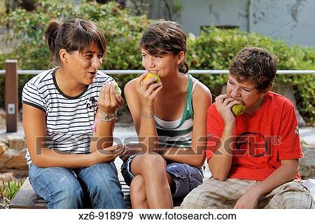 Teenagers eating fruit View Large Photo Image Stock Photo - Teenagers eating fruit. Fotosearch