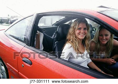 Teenagers in a red car View Large Photo Image Stock Image - Teenagers in a red car. Fotosearch
