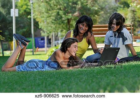 teenagers in the park with a PC View Large Photo Image Stock Photography - teenagers in the park with a PC. Fotosearch