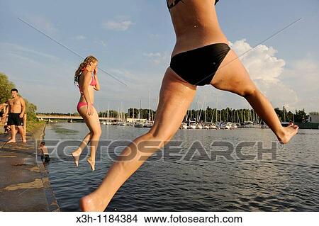 teenagers jumping in the water, Pirita's harbour, Tallinn, estonia, northern europe View Large Photo Image Picture - teenagers jumping in the water, Pirita's harbour, Tallinn, estonia, northern europe. Fotosearch