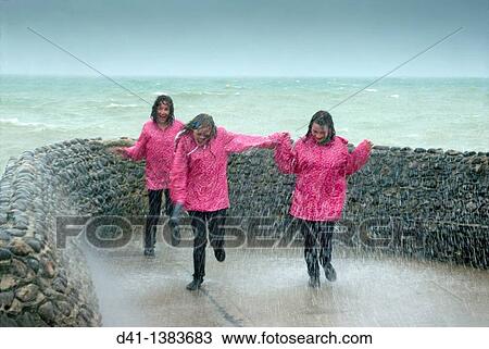 teenagers pink raincoats trio View Large Photo Image Stock Image - teenagers pink raincoats trio. Fotosearch