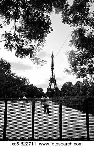 Stock Image - Teenagers playing soccer in Champ-de-Mars Paris. Fotosearch