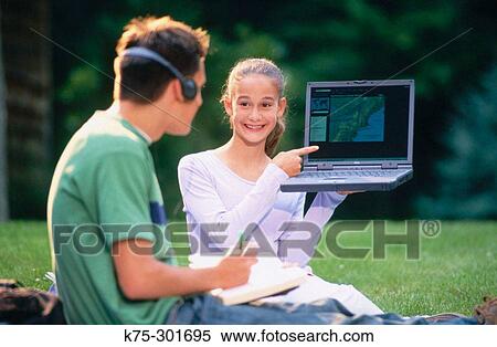 teenagers sharing laptop outdoors View Large Photo Image Stock Photography - teenagers sharing laptop outdoors. Fotosearch