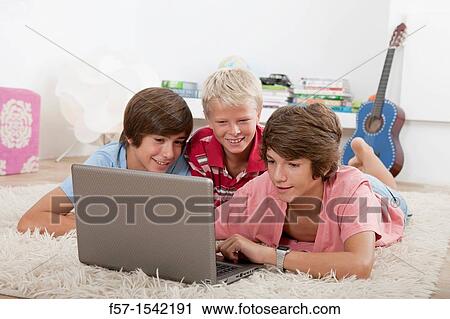 Teenagers surfing the net View Large Photo Image Stock Image - Teenagers surfing the net. Fotosearch
