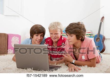 Teenagers surfing the net View Large Photo Image Stock Photo - Teenagers surfing the net. Fotosearch