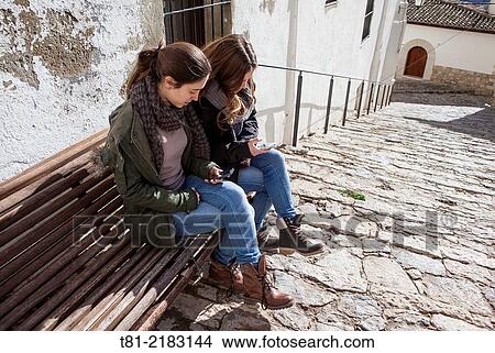 Teenagers talking on the phone in Morella, Castell? n, Valencia, Spain View Large Photo Image Picture - Teenagers talking on the phone in Morella, Castell? n, Valencia, Spain. Fotosearch
