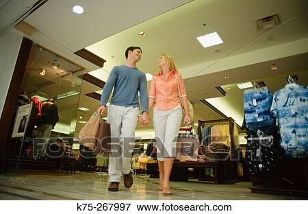 Teenagers with their purchases in mall View Large Photo Image Stock Photo - Teenagers with their purchases in mall. Fotosearch